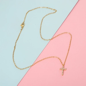 Minimalist gold stainless steel necklace with a sparkling crystal cross pendant