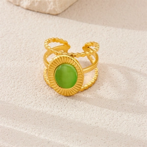 Detail of 18k gold plated stainless steel ring with green cat eye stone on stone decor
