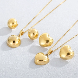 Golden heart necklace and sphere earring set in polished stainless steel for women