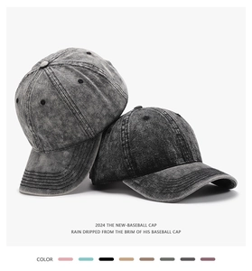 Detail of washed cotton baseball caps in dark grey and black with breathable eyelets