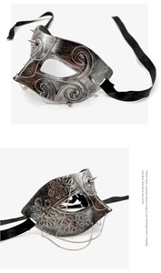 Detail of vintage punk half-face mask with metallic chains and silver-black rivets