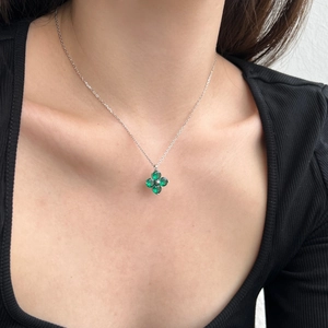 Close-up of model wearing a S925 silver necklace with a green clover zircon pendant