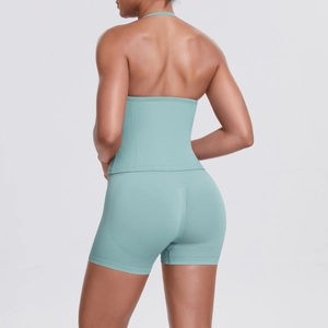 Detailed close-up of mint green seamless ribbed high-waist yoga shorts and sports bra