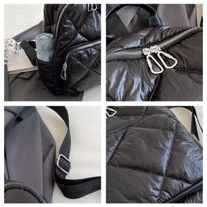 Detailaufnahmen von gestepptem schwarzem Nylon-Rucksack mit silbernen Reißverschlüssen