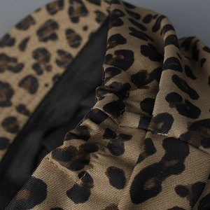 Macro view of leopard print fabric detail with elastic ruched pleats and fine texture