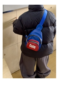 Detail view of boys' color-block chest bag with adjustable blue strap and Cute print