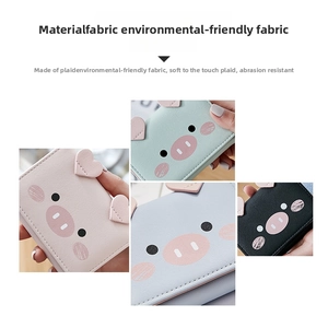 Detailed view of trifold cartoon pig wallets in four colors made of eco-friendly fabric