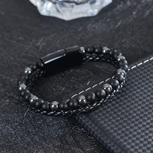 Men's double-layer bracelet with tiger eye beads and woven leather on a checkered surface