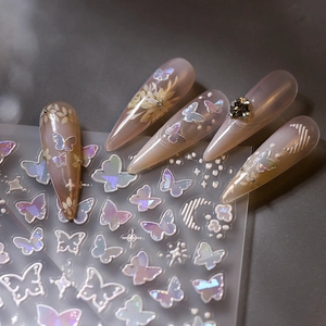 3D embossed iridescent nail stickers with butterfly and star motifs on almond nails
