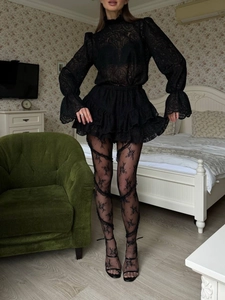 Detail of high collar lace top with lantern sleeves and tiered mesh skirt set
