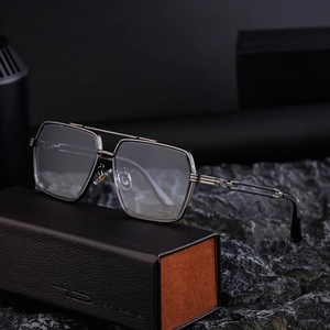 Retro pilot square sunglasses with gunmetal metal frame on leather case over stone background