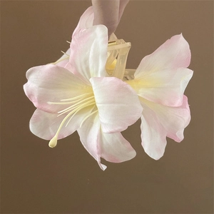 Detailed view of 3D lily flower hair claw clip with pink and yellow gradient petals