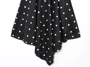 Detail shot of black and white polka dot fabric with high-quality hem stitching and texture