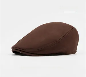 Detail of coffee brown cotton newsboy cap with refined stitching and vintage texture