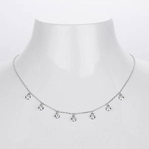 Detailed view of silver S925 necklace with seven round bezel-set zircon charms on a model