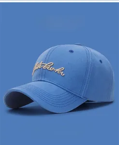 Detailed view of royal blue cotton baseball cap with premium gold thread embroidery