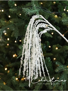 Close-up of white glitter Christmas spray branches with sparkling sequins for festive decor