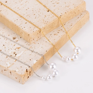 Elegant gold and silver stainless steel necklaces with gradient sized pearls on stone