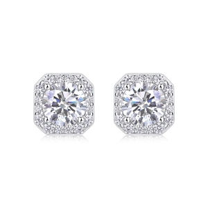 Macro shot of silver studs featuring a round center stone and octagonal halo setting