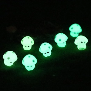 Eight glowing miniature mushroom figurines made of green luminous resin for micro landscapes