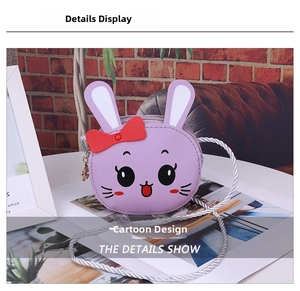 Detail shot of purple rabbit crossbody bag with red bow and silver braided strap