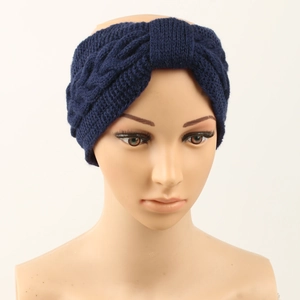 Detail of navy blue fleece-lined knitted headband with a textured twist on a model