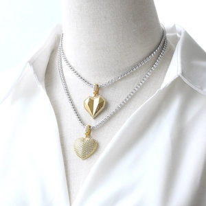 Elegant gold heart pendant necklace layered with a shimmering zircon studded tennis chain