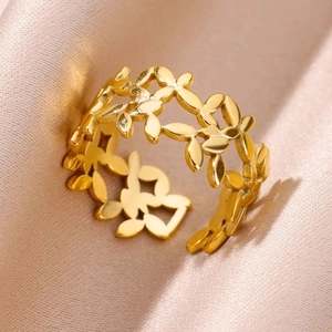 Detail of gold hollow leaf ring with sparkling zircons on pink silk fabric background