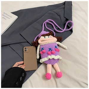 Detail of hand-knitted purple girl-shaped crossbody bag with 3D cherry and pearl decor