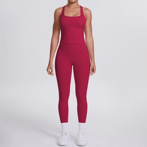 Detail of high-waist yoga leggings and racerback sports bra in dark rose pink fabric