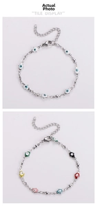 Detailed view of Hamsa Hand and Evil Eye charm bracelets in silver and colorful enamel