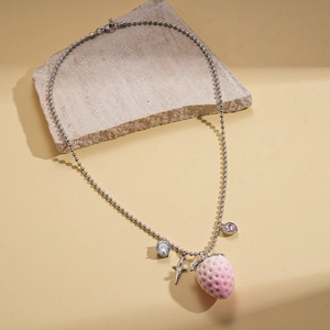 Silver bead chain necklace with pink velvet strawberry, star charms, and zircons on a stone