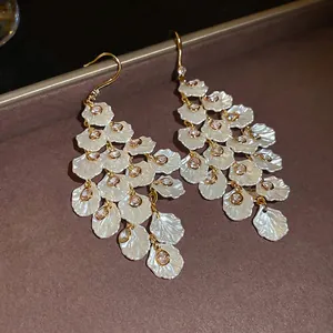 Elegant gold drop earrings with tiered white petals and sparkling crystals for women