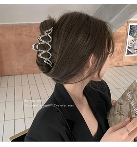 Silver wavy metal hair claw clip shown on model for a stylish half-up hairstyle