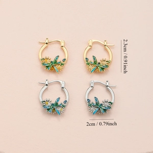 Elegant gold and silver dragonfly daisy hoop earrings with green enamel wings detail