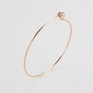 Detail of rose gold 1.5mm stainless steel wire bracelet with removable screw ball beads