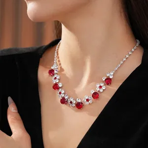 Elegant silver flower necklace with red zircon and sparkling crystals on model