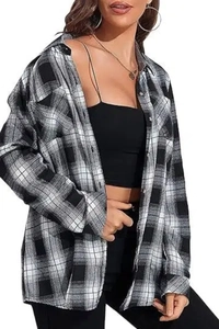 Detail of black and white plaid flannel texture on loose long-sleeved shirt for women