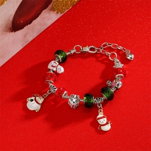Christmas snowman bracelet with red crystal beads and festive pendants on a red background