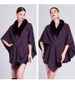 Detailed view of dark purple knit poncho featuring faux rabbit fur collar and pompom charms