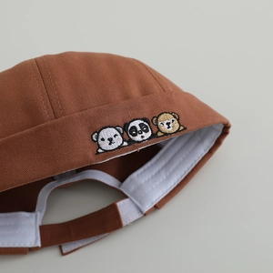 Brown cotton kids pumpkin hat with cute animal embroidery showing detailed craftsmanship