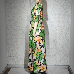 Détail de l'imprimé floral tropical sur une robe longue fendue aux motifs d'été vibrants