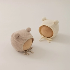 Detailed close-up of waffle texture cotton baby hats with cute double ears and chin straps