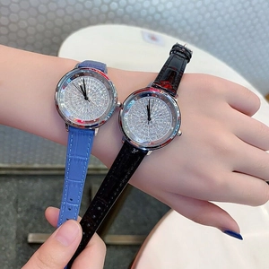 Detail of luxury women's wristwatches with diamond-set dials and colorful leather straps