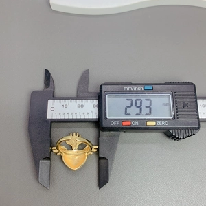 Detailed measurement showing 29.3 mm height of gold Claddagh ring with digital calipers
