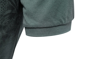 Close-up of ribbed cuffs and breathable mesh fabric on a men's polo shirt