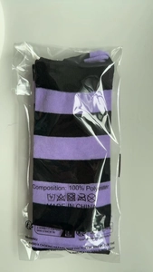 Detail view of purple and black striped knit socks in 100% polyester retail packaging