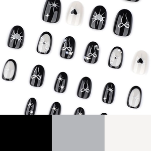 Gothic black and white almond press-on nails with bow, heart and pearl decorations