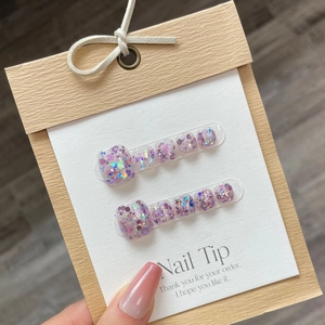 Pink glitter press-on toenails with multi-size nail tips on professional display card