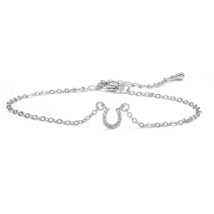 Detailed macro view of silver horseshoe pendant bracelet with sparkling cubic zirconia